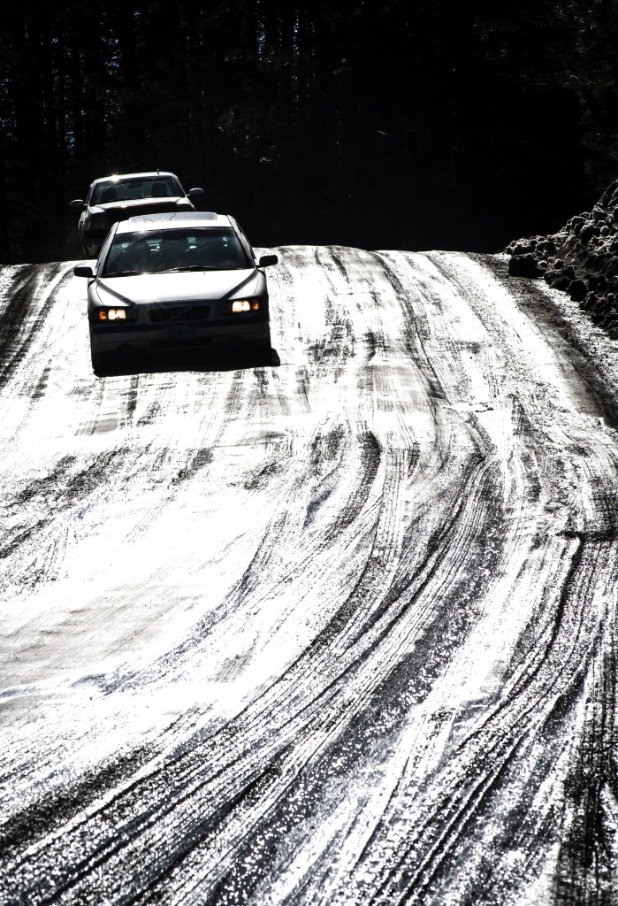 Mark Collier / Staff Photo Warm temperatures and beautiful weather made for melting snow and muddy Lower Road between Barre and Plainfield Saturday. The brilliant light of the sun reflecting off the road turned the vehicles inching their way along into surreal silhouettes,